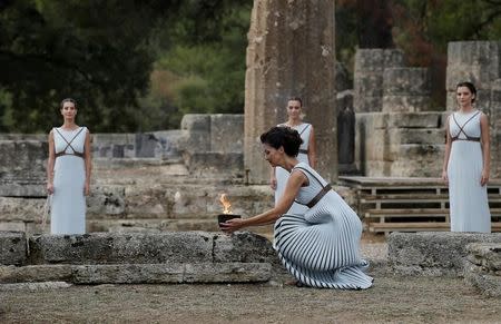 Olympics - Lighting Ceremony of the Olympic Flame Pyeongchang 2018 - Ancient Olympia, Olympia, Greece - October 24, 2017 Greek actress Katerina Lehou, playing the role of High Priestess with the flame during the Olympic flame lighting ceremony for the Pyeongchang 2018 Winter Olympics REUTERS/Alkis Konstantinidis