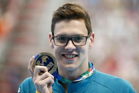 Australia's Mitchell Larkin celebrates with his gold medal after winning the men's 200m backstroke final at the Aquatics World Championships in Kazan, Russia August 7, 2015. REUTERS/Stefan Wermuth