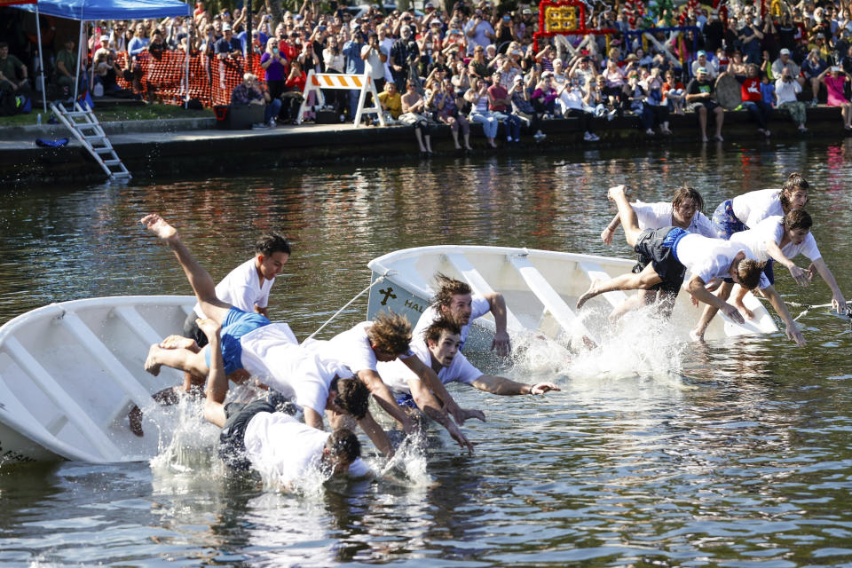 Cross divers leap into the water when the cross is thrown during the annual cross dive in the Spring Bayou, part of the Epiphany celebration on Saturday, Jan. 6, 2024, in Tarpon Springs, Fla. (Jefferee Woo/Tampa Bay Times via AP)