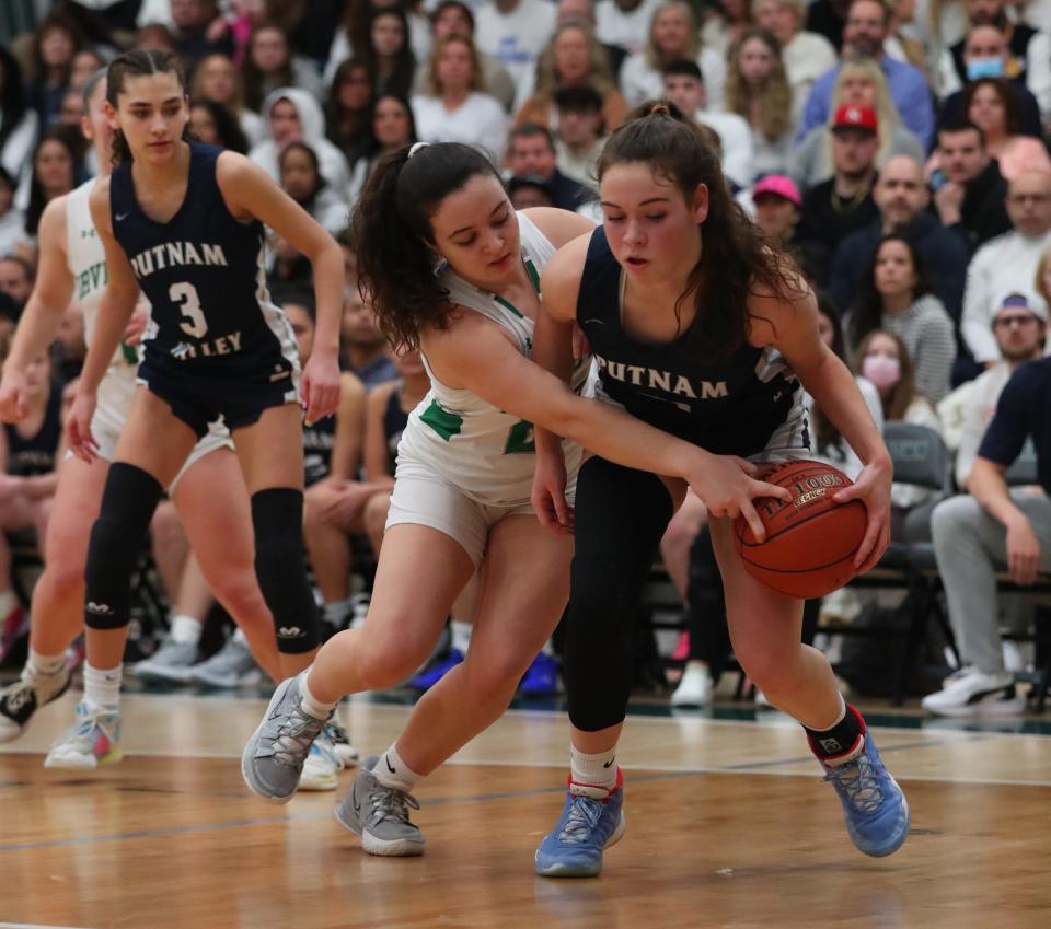 Putnam Valley's Eva DeChent (21) and Irvington's Alyson Raimondo (20) battle for possession during the girls Section 1 Class B championship basketball game at Yorktown High School in Yorktown Heights on Saturday, March 5, 2022.