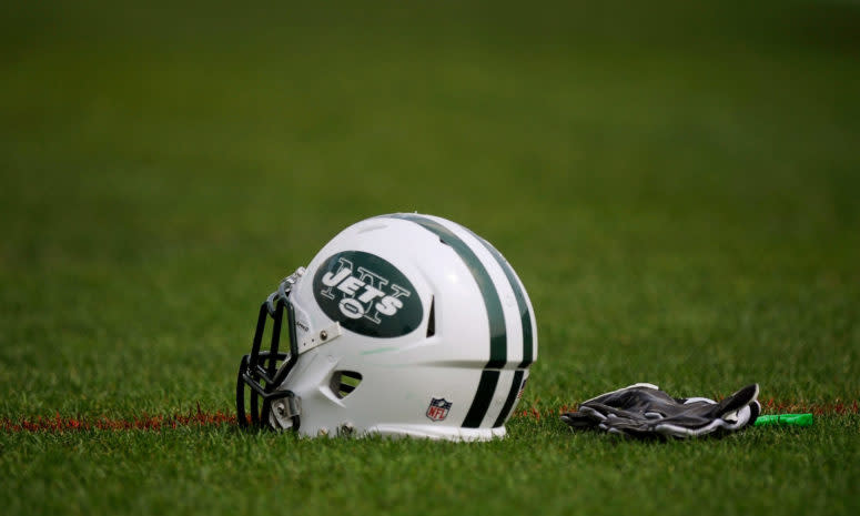 A New York Jets helmet sitting on the field.