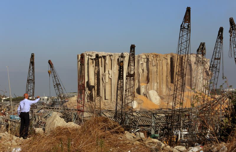 A man stands near the damaged grain silos following Tuesday's blast at Beirut's port area