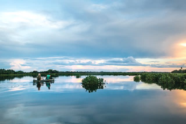 <p>Carmen Campos</p> Guests at Casa Caiman take a sunset canoe tour in Brazil's Pantanal wetlands.