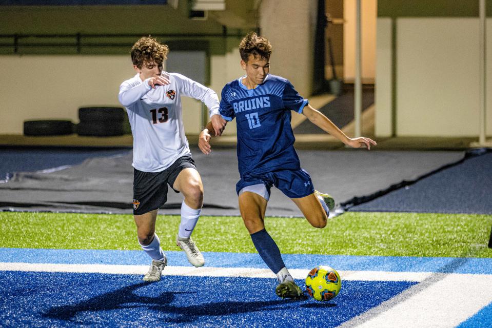 Bartlesville's Braxton Decker battles on the sideline during Tuesday night's game.