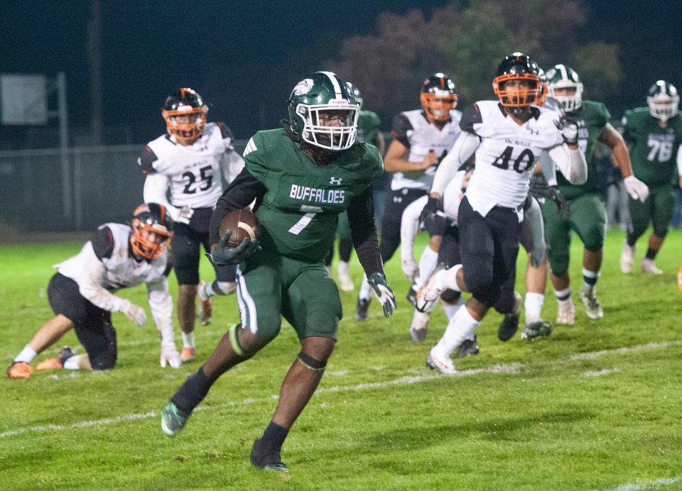 Manteca's Bryson Davis evades Vacaville defense during their 2022 CIF Sac-Joaquin Section Football playoff game  in Manteca Fri., Nov 11, 2022. 