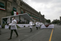 Medical workers who tend to COVID-19 patients pick up their medals, awarded to them by the government in recognition of their efforts in the pandemic, during the annual Independence Day military parade in Mexico City’s main square of the capital, the Zócalo, Wednesday, Sept. 16, 2020. Mexico celebrates the anniversary of its independence uprising of 1810. ( AP Photo/Marco Ugarte)