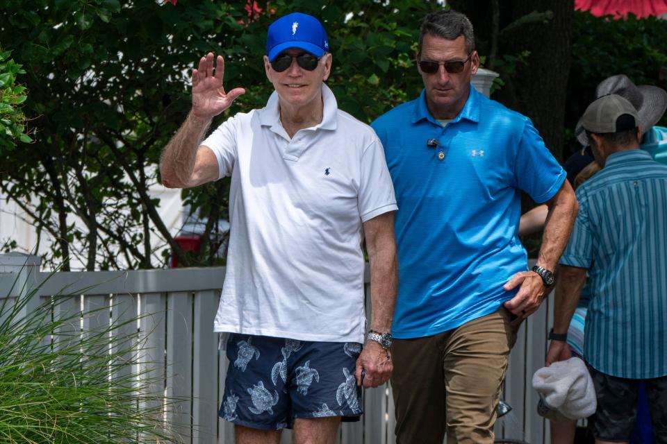 President Joe Biden waves to members of the media as he walks back to his motorcade after visiting the beach, Saturday, July 8, 2023, near his home near Rehoboth Beach, where Biden was spending the weekend.