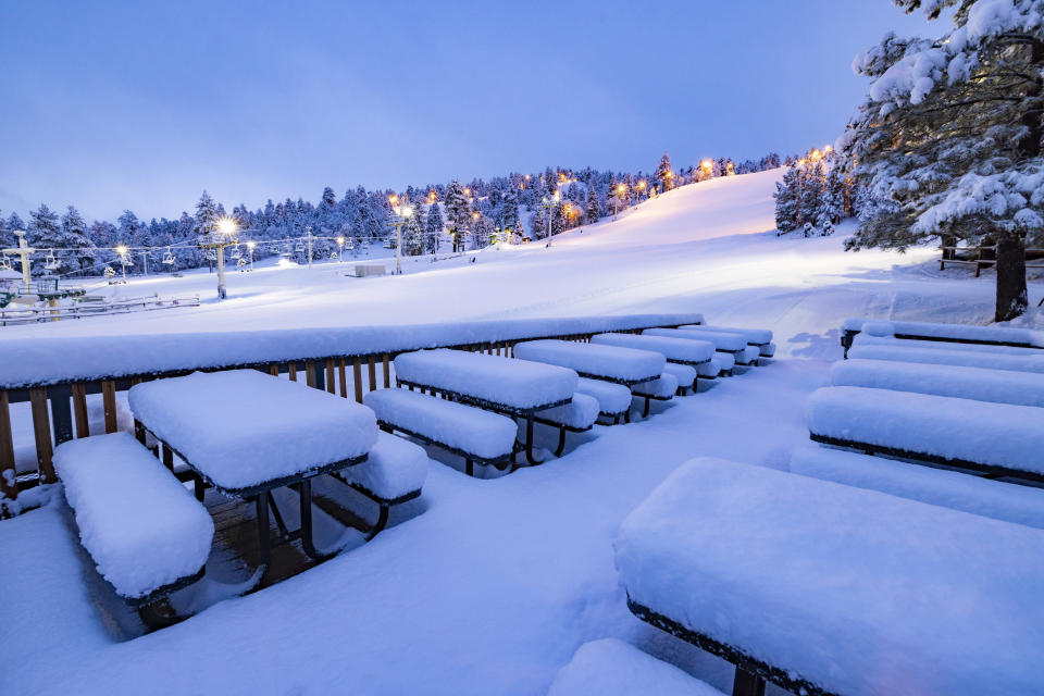 In this photo provided by Big Bear Mountain Resort, snow covers a number of tables at the resort in Big Bear Lake, Calif., Tuesday Feb. 6, 2024. The resort has received three feet of new snow over the last week, with some of the heaviest periods of snowfall occurring last night. (Big Bear Mountain Resort via AP)