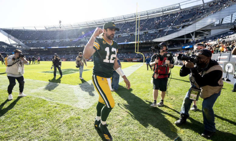 Aaron Rodgers runs off the field in Chicago after beating the Bears.