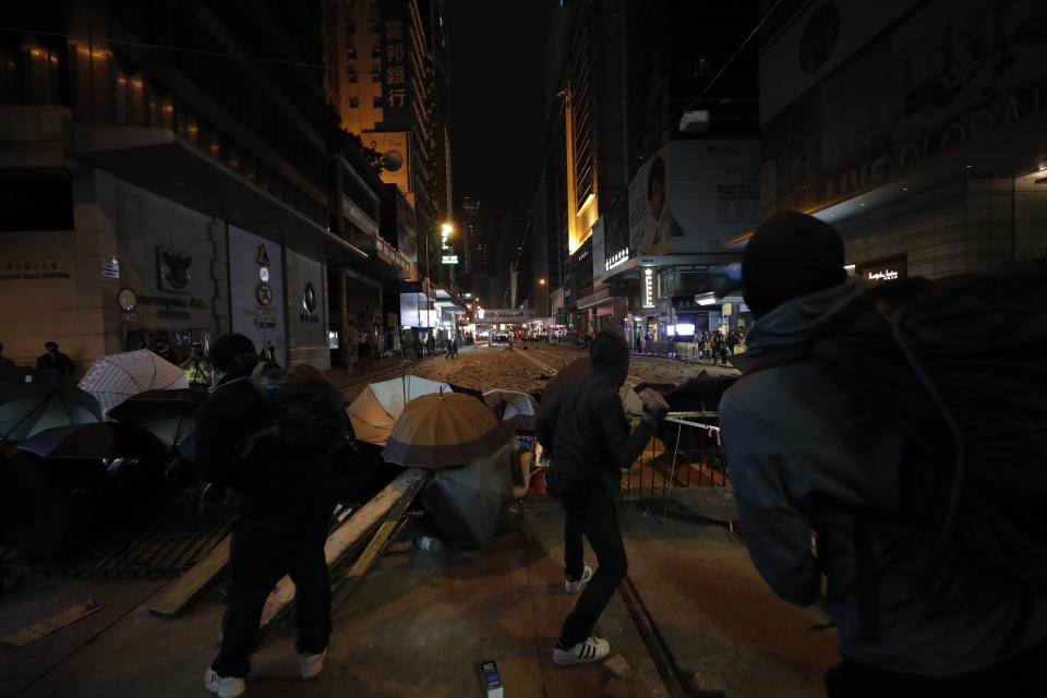 Protestors throw stones at police in Hong Kong, Wednesday, Jan. 1, 2020. Hong Kong toned down its New Year’s celebrations amid the protests that began in June and which have dealt severe blows to the city’s retail, tourism and nightlife sectors. (AP Photo/Lee Jin-man)