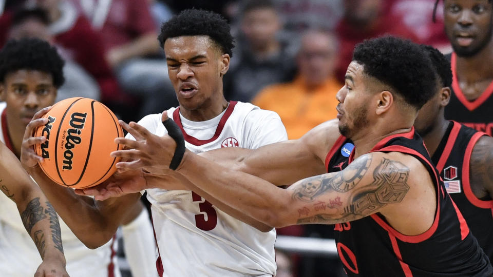 Alabama guard Rylan Griffen (3) battles for the ball against San Diego State guard Matt Bradley (20) in the first half of a Sweet 16 round college basketball game in the South Regional of the NCAA Tournament, Friday, March 24, 2023, in Louisville, Ky. (AP Photo/Timothy D. Easley)