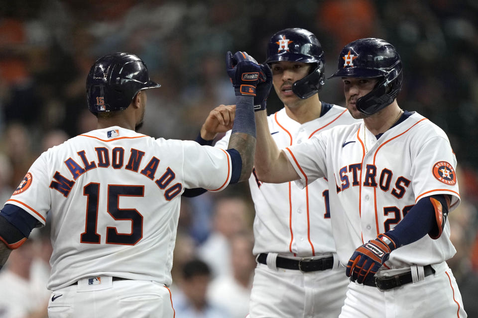 Houston Astros' Chas McCormick (20) celebrates with Martin Maldonado (15) after hitting a two-run home run against the Texas Rangers during the second inning of a baseball game Wednesday, June 16, 2021, in Houston. (AP Photo/David J. Phillip)