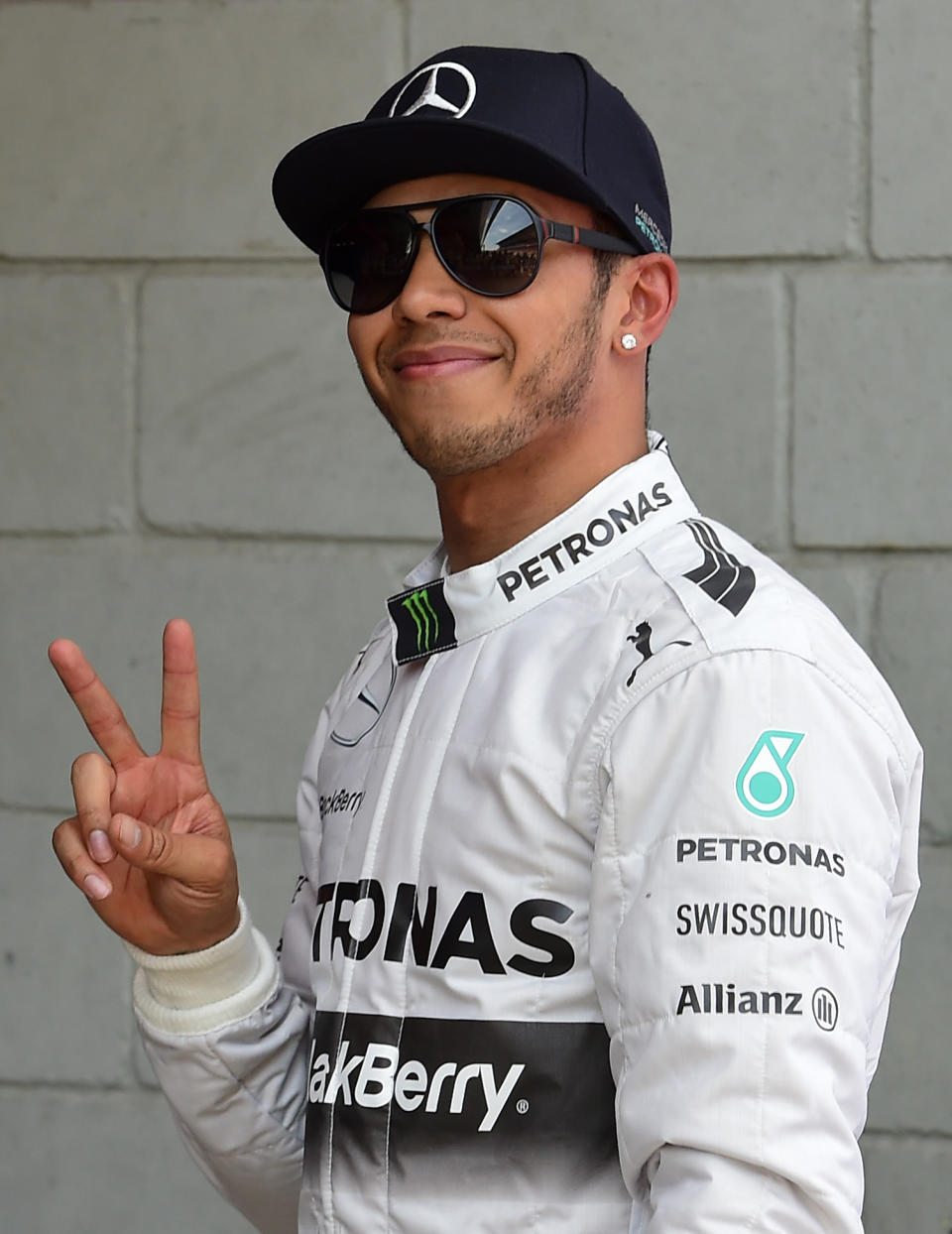 Mercedes driver Lewis Hamilton of Britain gestures after setting the pole position in the qualifying session ahead of the Spain Formula One Grand Prix at the Barcelona Catalunya racetrack in Montmelo, near Barcelona, Spain, Saturday, May 10, 2014. Lewis Hamilton earned his fourth pole position of the Formula One season Saturday as Mercedes was again in a class of its own in qualifying for the Spanish Grand Prix, while four-time champion Sebastian Vettel was left stranded by his faulty Red Bull. Hamilton clocked a leading lap of 1 minute, 25.232 seconds on the Barcelona-Catalunya circuit for his 35th career pole. (AP Photo/Manu Fernandez)