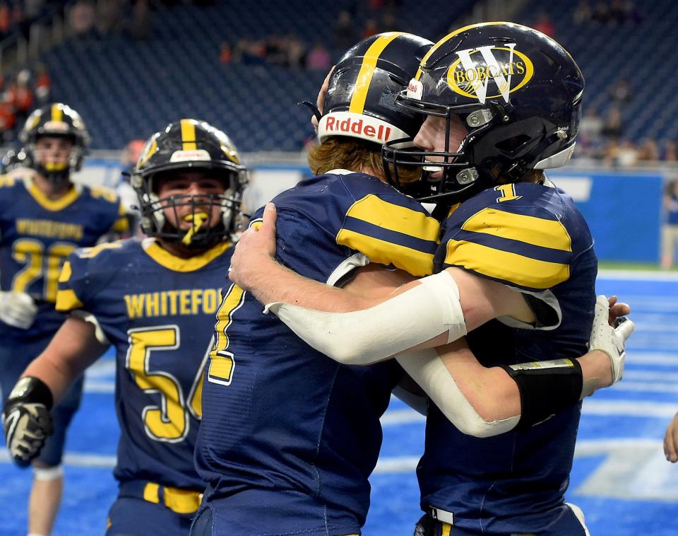 Whiteford's Ryin Ruddy hugs his brother quarterback Shea Ruddy after he scored the final touchdown late in the fourth quarter beating Ubly 26-20 in the Division 8 State Championships at Ford Field Friday.