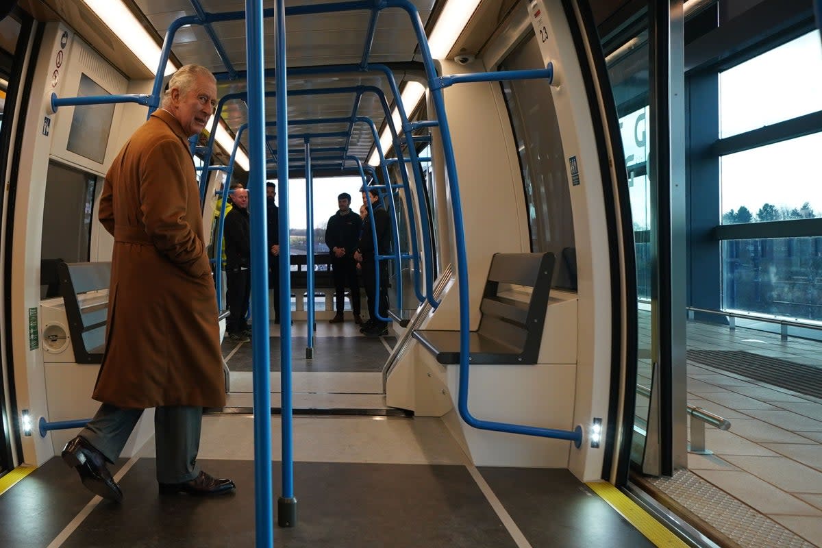 Priced for a king: Charles III aboard the Luton airport Dart, which charges £4.90 for a 1.3-mile trip (Yui Mok/PA) (PA Wire)