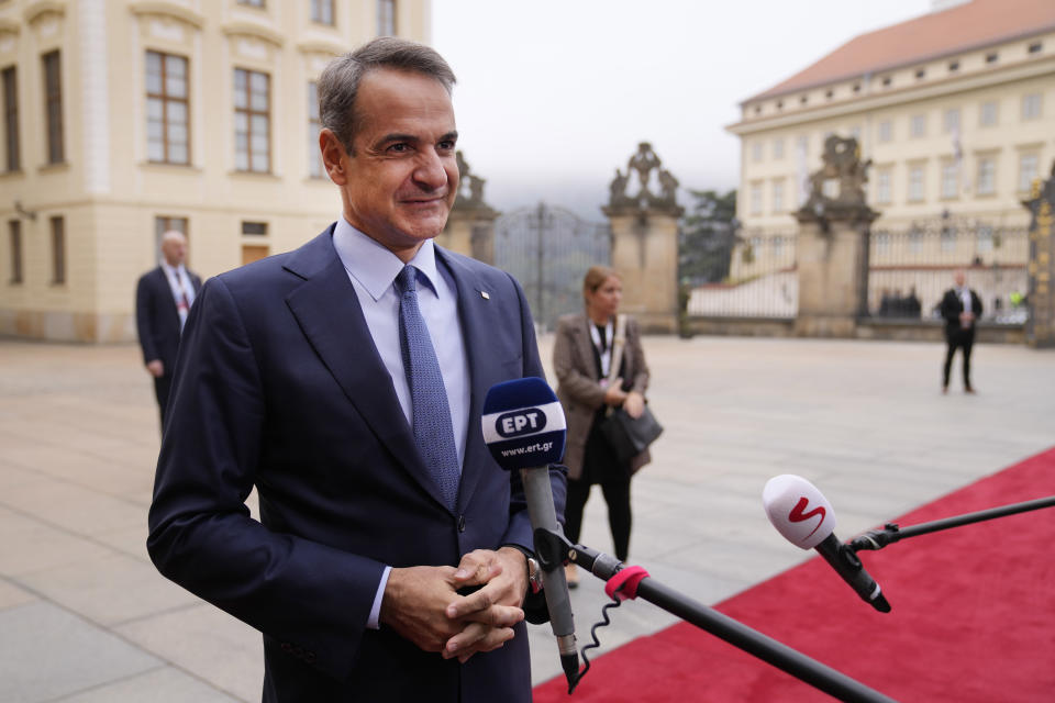 Greece's Prime Minister Kyriakos Mitsotakis speaks with the media as he arrives for an EU Summit at Prague Castle in Prague, Czech Republic, Friday, Oct 7, 2022. European Union leaders converged on Prague Castle Friday to try to bridge significant differences over a natural gas price cap as winter approaches and Russia's war on Ukraine fuels a major energy crisis. (AP Photo/Darko Bandic)