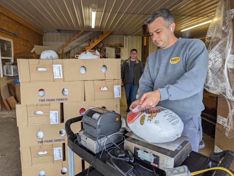 Matt Damschroder is the fourth-generation owner of Roots Poultry. He weighs out turkeys in the warehouse, as they prepare for their retail Thanksgiving sales.