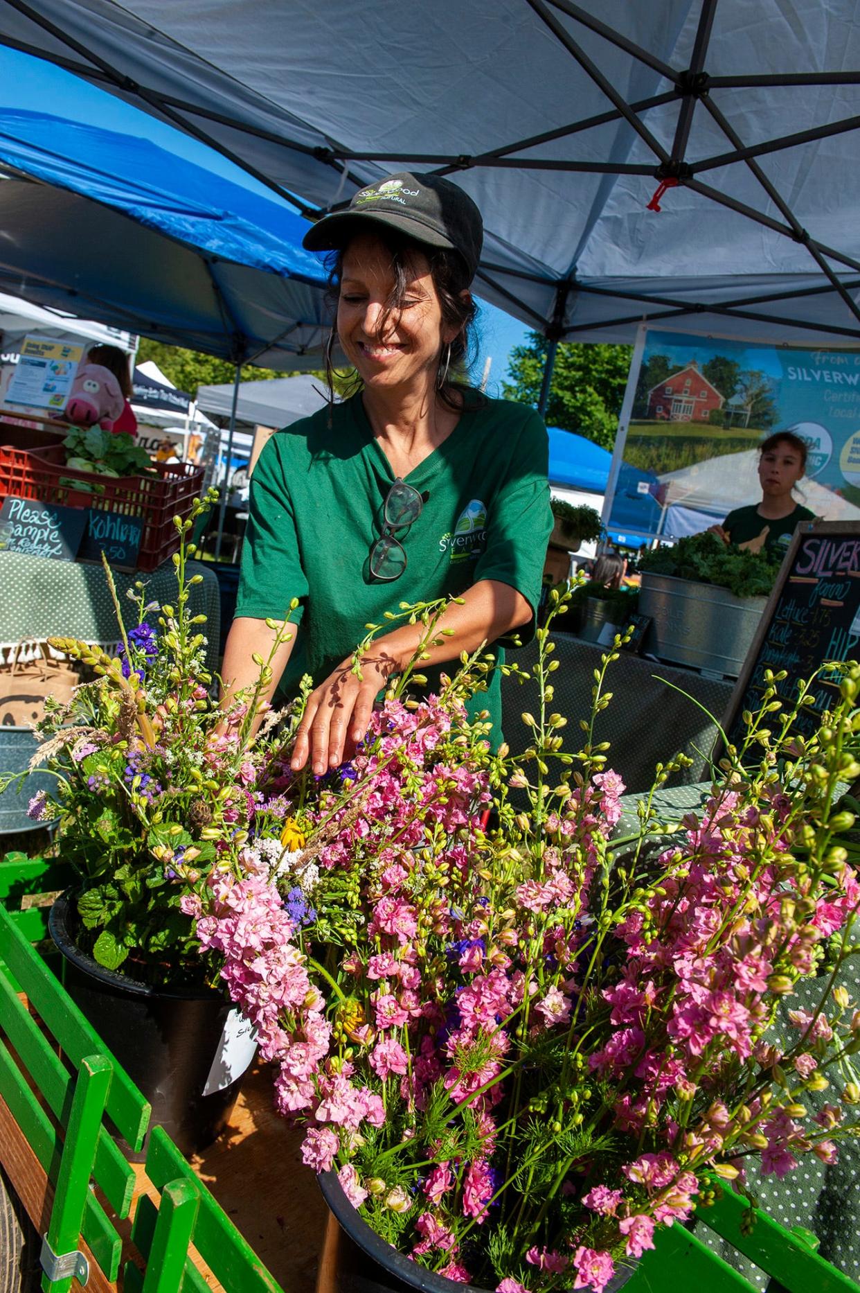 Laura Raney, of Silverwood Organic Farm in Sherborn, sells flowers during the Framingham Farmers Market's opening day, June 22, 2023.