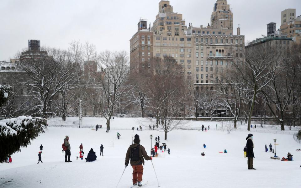 People enjoy new fallen snow in Central Park - REUTERS/Mike Segar