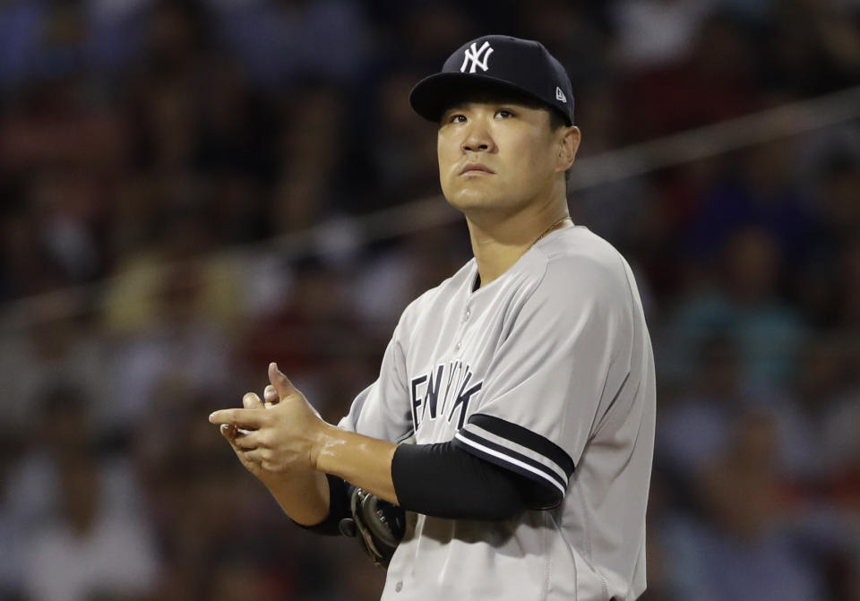 New York Yankees starting pitcher Masahiro Tanaka rubs the ball as he is taken out in the fourth inning of a baseball game against the Boston Red Sox at Fenway Park, Thursday, July 25, 2019, in Boston. (AP Photo/Elise Amendola)