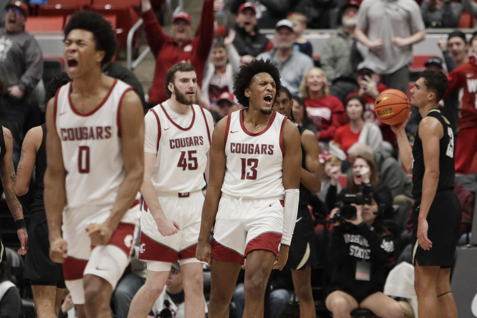Washington State forward Isaac Jones (13) celebrates his basket and drawing a foul along with forward Jaylen Wells (0) during the second half of an NCAA college basketball game against Colorado, Saturday, Jan. 27, 2024, in Pullman, Wash. Washington State won 78-69. (AP Photo/Young Kwak)