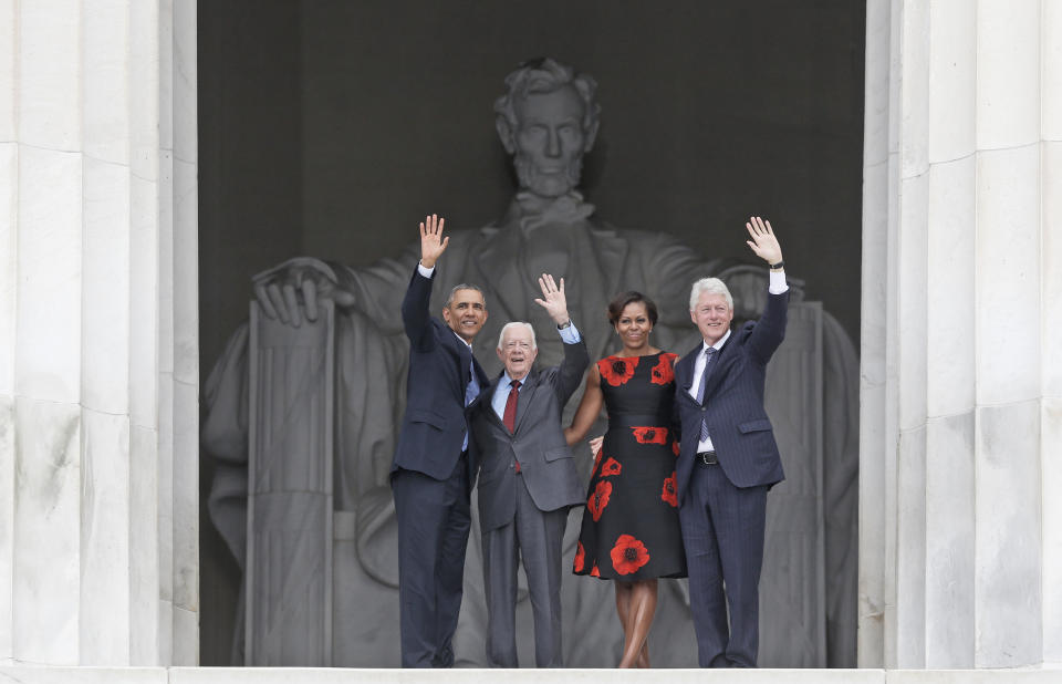 FILE - President Barack Obama and first lady Michelle Obama, former President Jimmy Carter and former President Bill Clinton wave as they leave 50th Anniversary of the March on Washington where Martin Luther King Jr., spoke in front of the Lincoln Memorial in Washington, Wednesday, Aug. 28, 2013. (AP Photo/Charles Dharapak, File)