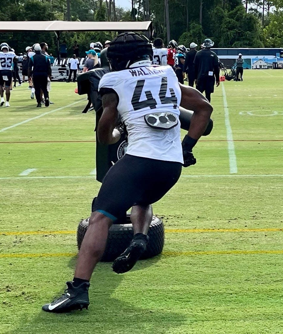 Jaguars outside linebacker Walker Little goes through a drill with a tackling dummy during Monday's training camp practice.
