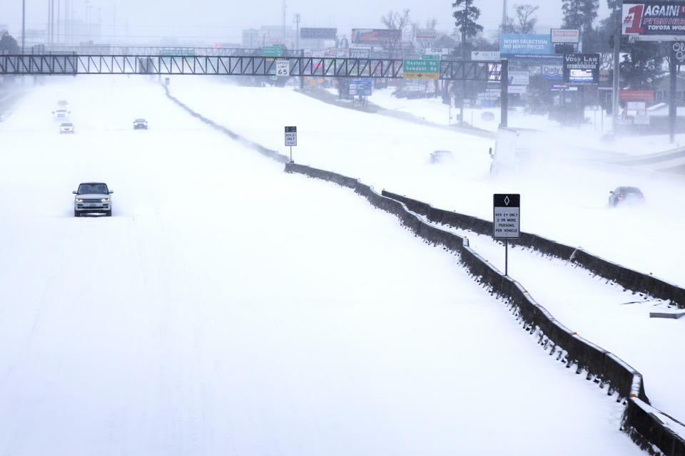 FILE - In this Feb. 15, 2021, file photo, traffic is sparse on the snow-covered Interstate 45 near The Woodlands Parkway following an overnight snowfall in The Woodlands, Texas. Temperatures plunged into the teens Monday with light snow and freezing rain. (Brett Coomer/Houston Chronicle via AP, File)