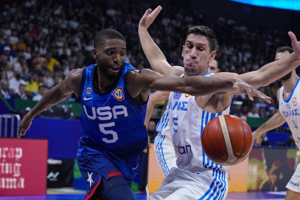 U.S. forward Mikal Bridges (5) recovers the ball in front of Greece guard Giannoulis Larentzakis (5) during the first half of a Basketball World Cup group C match in Manila, Philippines Monday, Aug. 28, 2023.(AP Photo/Michael Conroy)