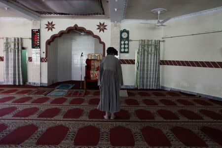 A man says his prayers at the Al Haaj mosque where Taliban chief Habibullah Akhundzada lived and taught for years in Kuchlak outside Quetta, Pakistan September 23, 2016. Picture taken September 23, 2016. REUTERS/Naseer Ahmed