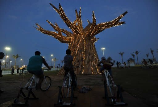 South Africans light up a Baobab tree by riding bikes in Durban in 2011 as part of a renewable energies display on the beach front during the UN Climate Change Conference (COP17). Climate change caused by global warming is freezing the world economy, a report commissioned by 20 of the world's most vulnerable countries said Wednesday