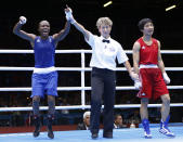 Britain's Nicola Adams (L) reacts as she is declared the winner over China's Ren Cancan during their Women's Fly (51kg) gold medal boxing match at the London Olympic Games August 9, 2012. REUTERS/Murad Sezer (BRITAIN - Tags: SPORT BOXING OLYMPICS TPX IMAGES OF THE DAY) 