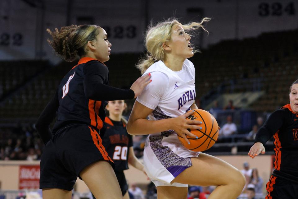 Community Christian's Laney Venables grabs a rebound beside Roland's Haven Freeman during a Class 3A girls state basketball game between Community Christian and Roland at State Fair Arena in Oklahoma City, Tuesday, March 5, 2024.