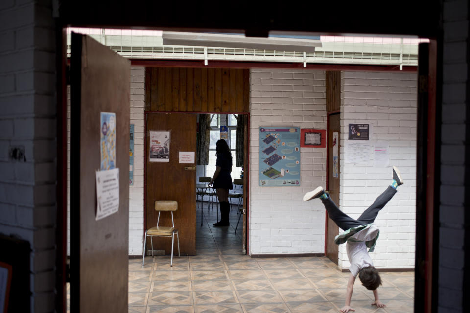 In this Dec.13, 2018 photo, Aurora, a transgender girl, does cartwheels in the Amaranta Gomez school, in Santiago, Chile. Activists and parents of transgender children say that's the stage of childhood or pre-adolescence when children discover that their gender does not correspond to their body. (AP Photo/Esteban Felix)