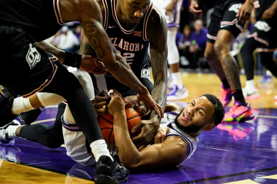 Kansas State guard Markquis Nowell (1) ties up Oklahoma State's Kalib Boone (22) for a held ball during the first half on Tuesday night at Bramlage Coliseum. K-State edged OSU, 65-57.