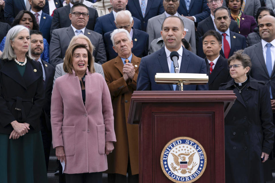 Incoming House Minority Leader Hakeem Jeffries, D-N.Y., accompanied by incoming House Minority Whip Rep. Katherine Clark, D-Mass., Rep. Nancy Pelosi, D-Calif., other members of Congress and family of fallen officers, speaks during a ceremony marking the second year anniversary of the violent insurrection by supporters of then-President Donald Trump, in Washington, Friday, Jan. 6, 2023. (AP Photo/Jose Luis Magana)