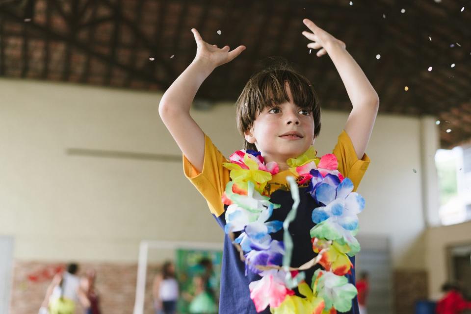 young boy wearing a floral lei