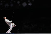 <p>South Korea's Gu Bongil celebrates scoring a point against Italy's Luca Curatoli in the men's sabre team gold medal bout at the Makuhari Messe Hall on July 28.</p>