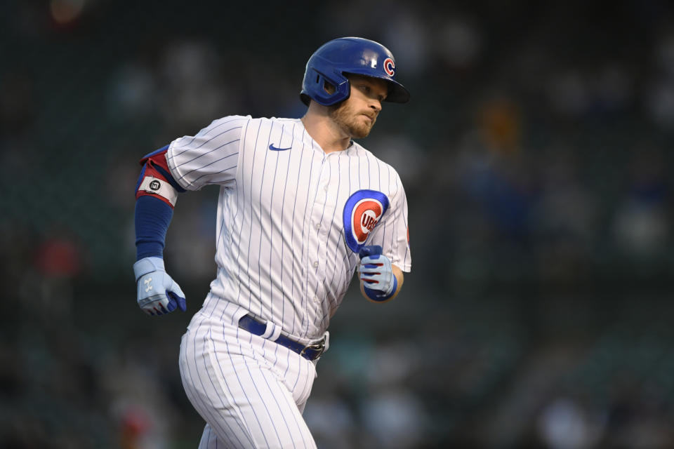 Chicago Cubs' Ian Happ rounds third base after hitting a solo home run during the first inning of the team's baseball game against the Cincinnati Reds on Wednesday, Sept. 8, 2021, in Chicago. (AP Photo/Paul Beaty)