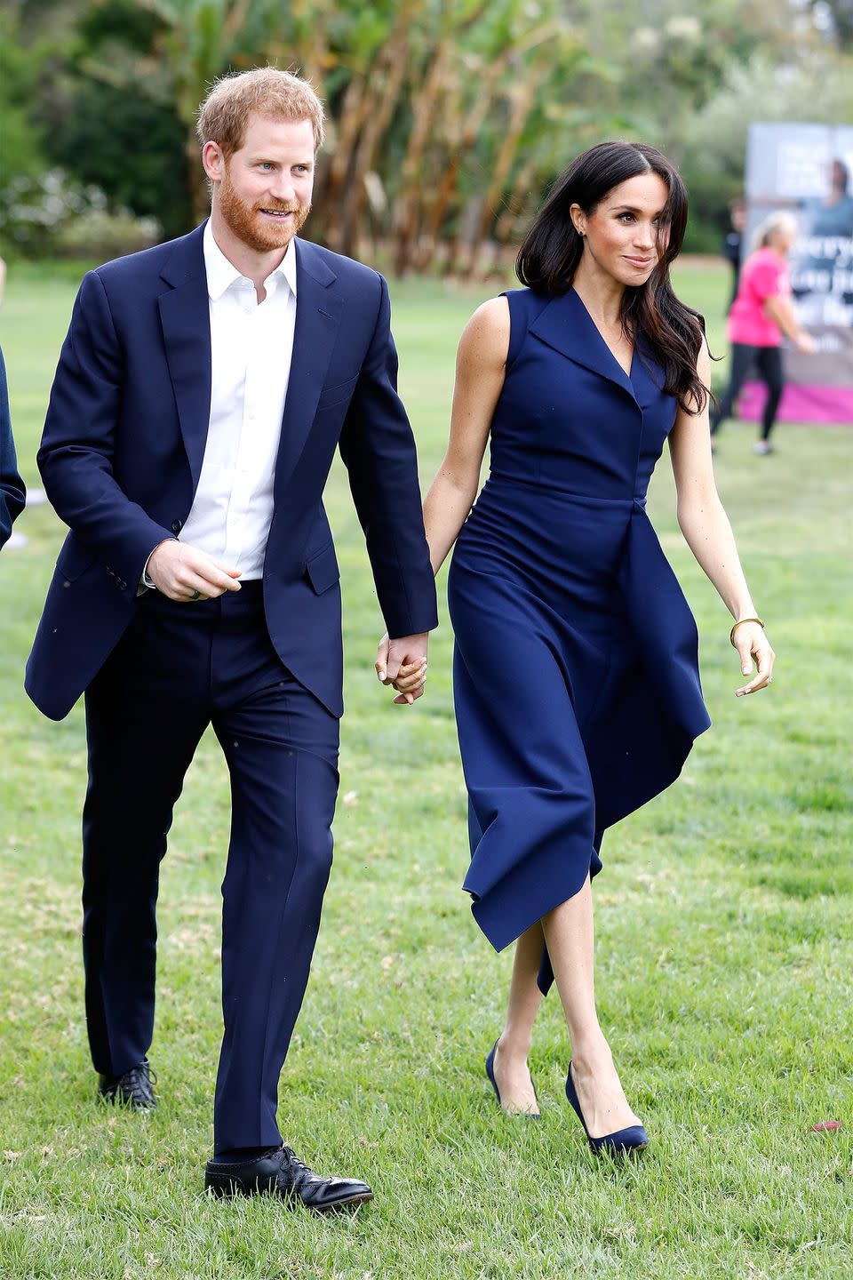 <p>Meghan wears the navy <a rel="nofollow noopener" href="https://www.harpersbazaar.com/celebrity/latest/a23888788/meghan-markle-royal-tour-australia-navy-dress-crashes-dion-lee-designer-website/" target="_blank" data-ylk="slk:Folded Sail dress by Dion Lee;elm:context_link;itc:0;sec:content-canvas" class="link ">Folded Sail dress by Dion Lee</a>.</p>