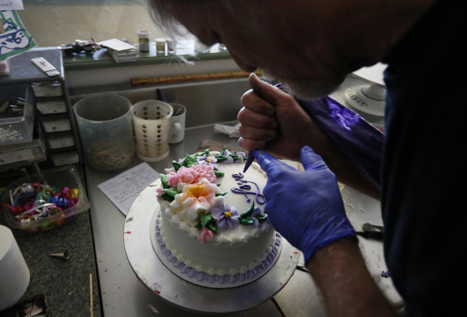 In this March 10, 2014 photo, Masterpiece Cakeshop owner Jack Phillips decorates a cake inside his store, in Lakewood, Colo. Phillips is appealing a recent ruling against him in a legal complaint filed with the Colorado Civil Rights Commission by a gay couple he refused to make a wedding cake for, based on his religious beliefs. (AP Photo/Brennan Linsley)