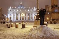 A couple hugs during a heavy snowfall at Saint Peter's Square at the Vatican February 10, 2012.