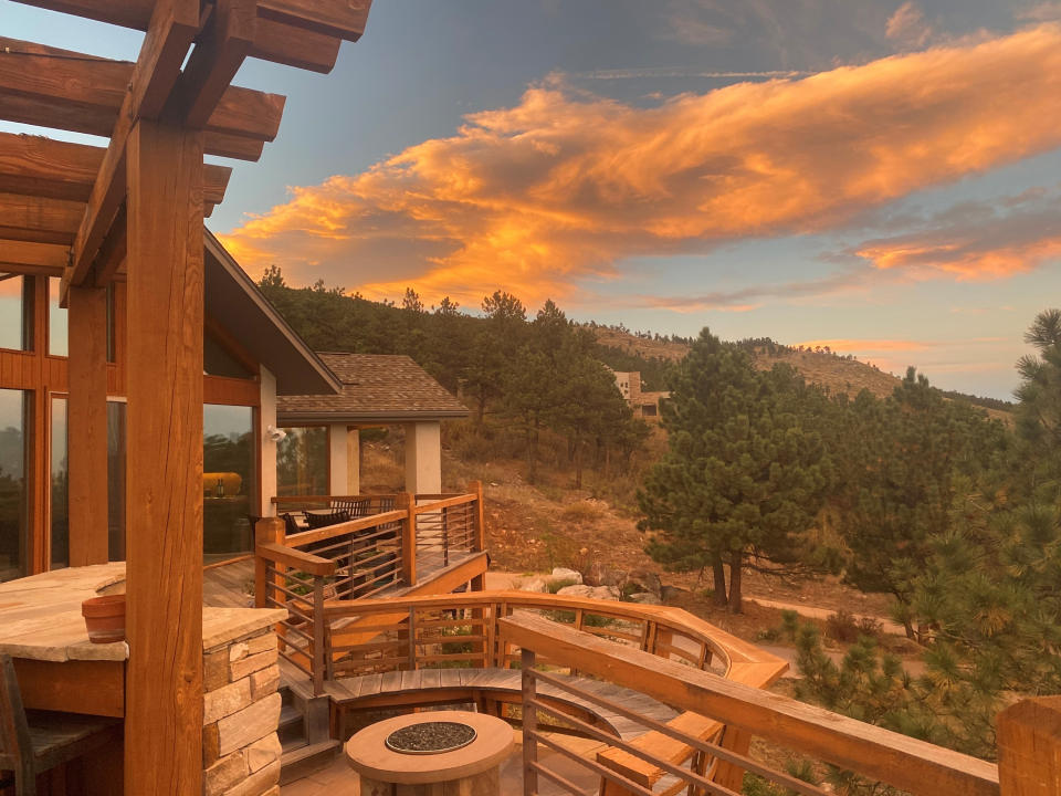 This Friday, Oct. 16, 2020, photo courtesy of Brian DeToy shows the home deck of Brian DeToy and his wife, Sheryl Shafer in Boulder, Colo. Orange skies, winds gusting up to 70 mph, smoke tornadoes and hazardous air. While it could be an apocalyptic scene out of a movie, it's become the reality of Colorado's wildfire season. (Brian DeToy via AP)