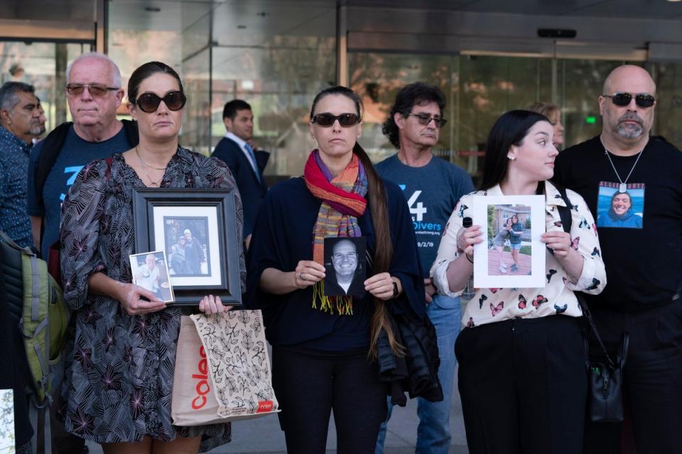 Family members  of the 34 people who died during the Conception dive boat fire in 2019 hold photos of their loved ones outside the US Federal Building in downtown Los Angeles (AP)