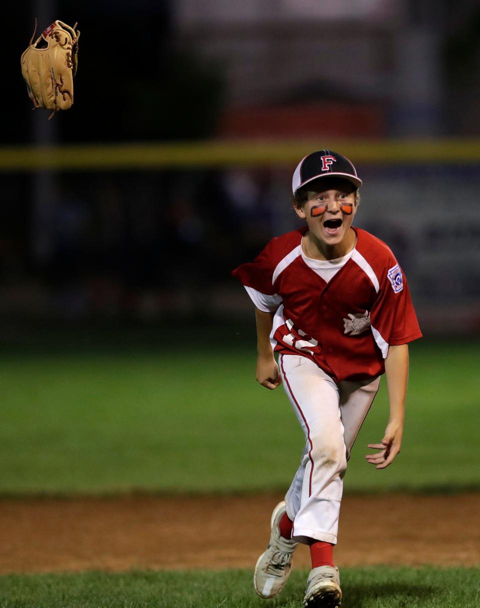 The Appleton Firefighters' Preston McGinnis celebrates a victory against Appleton Police during their Little League Major Baseball City Championship game June 30 at Scheels USA Youth Sports Complex in Appleton. Appleton Firefighters won 8-0.