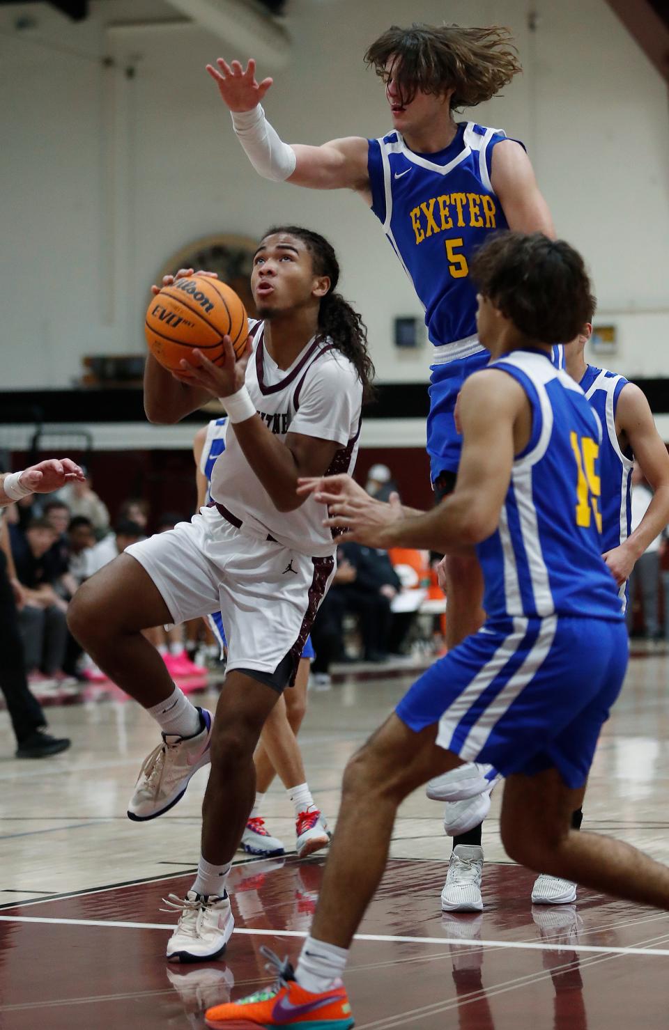 Mt. Whitney's Israel Briggs goes in for two points against Exeter's Blaine McFall during their 72nd annual Polly Wilhelmsen Invitational Basketball Tournament game in Visalia, Calif., Wednesday, Dec. 27, 2023.