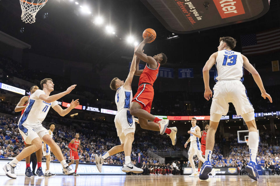 St. John's Nahiem Alleyne, second right, shoots over Creighton's Francisco Farabello, center, during the first half of an NCAA college basketball game Saturday, Jan. 13, 2024, in Omaha, Neb. (AP Photo/Rebecca S. Gratz)