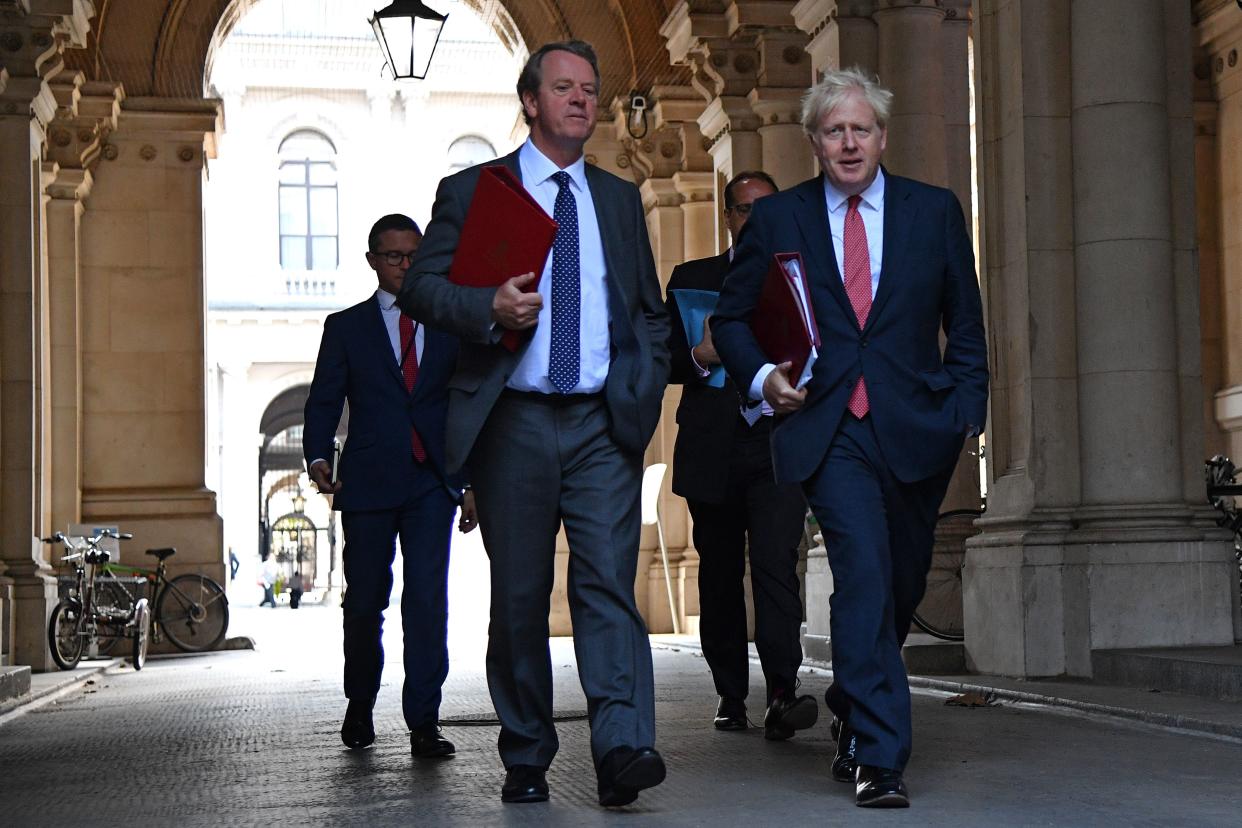 Britain's Prime Minister Boris Johnson (R) returns with Britain's Scotland Secretary Alister Jack (L) to Downing Street in central London on September 1, 2020 after holding the first weekly meeting of the cabinet since the summer recess in the Foreign and Commonwealth Office. - The UK Parliament returned to work on September 1 with the governing Conservative Party having taking a summer of hits in the polls bringing them level with the main opposition Labour Party amid a series of embarrassing U-turns and economic devastation wrought by the coronavirus pandemic. (Photo by JUSTIN TALLIS / AFP) (Photo by JUSTIN TALLIS/AFP via Getty Images)