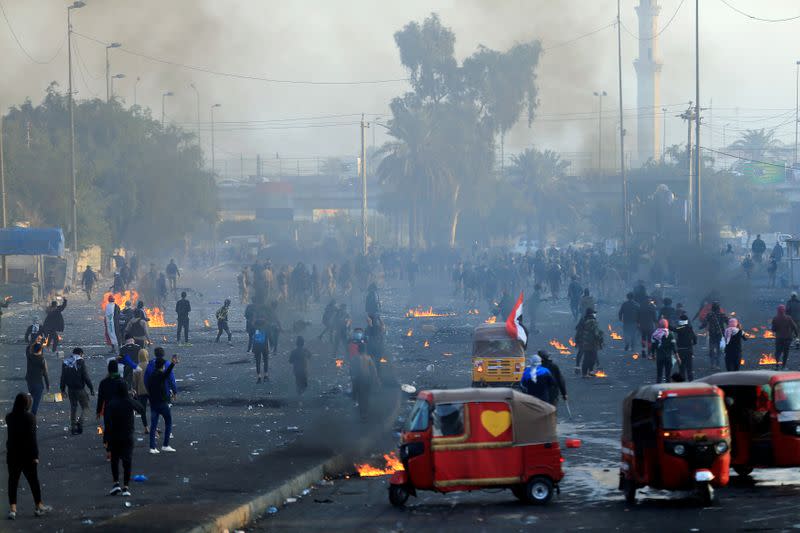 Iraqi demonstrators use tuc-tuc during ongoing anti-government protests in Baghdad