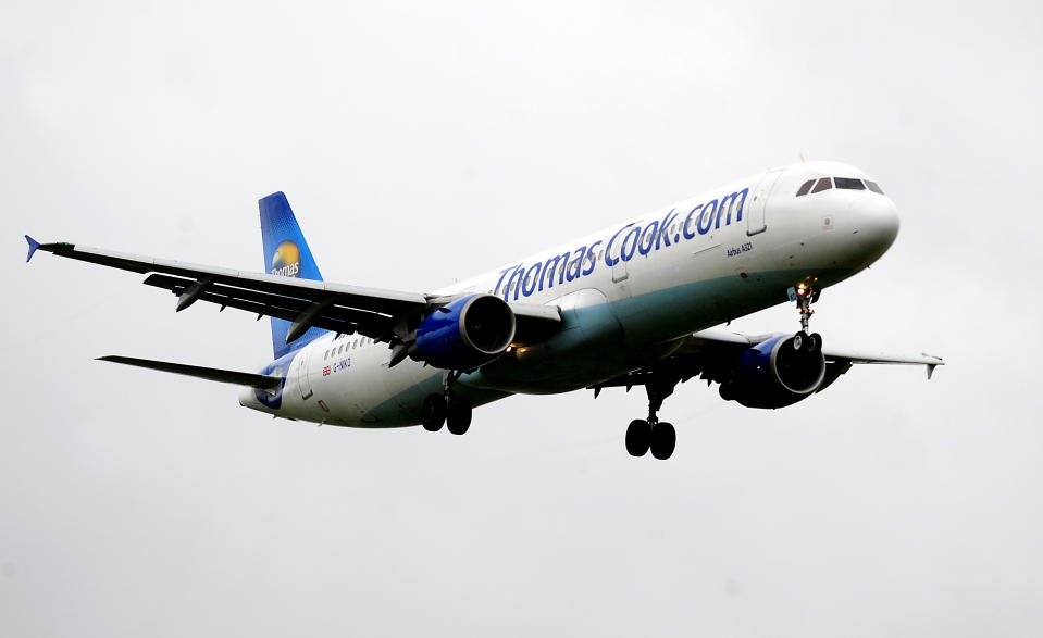 A Thomas Cook plane lands at East Midlands Airport, Derbyshire.